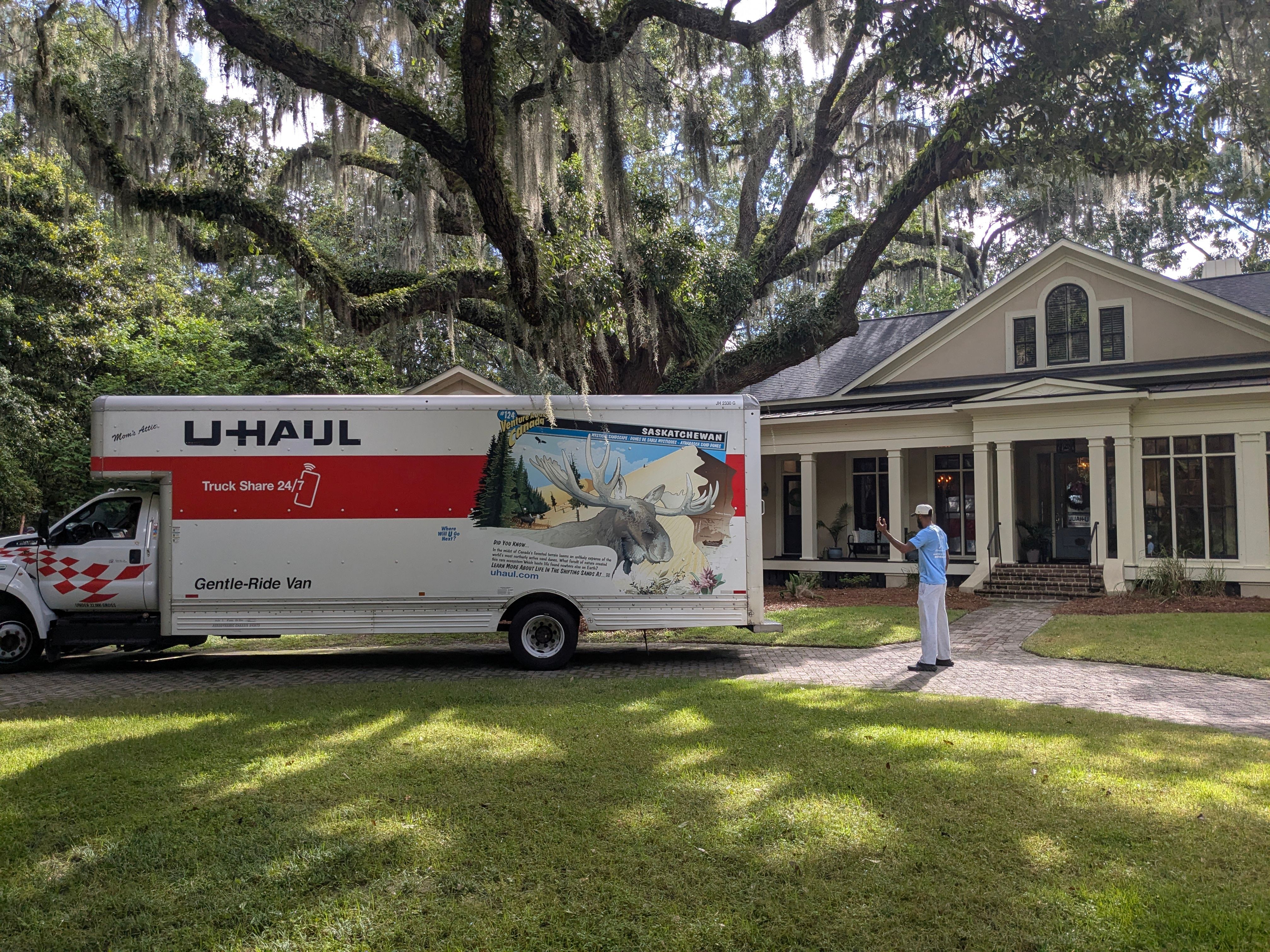 Mover Backing Up U Haul Truck In Front Of Home